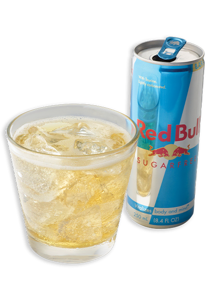 Tito’s and Red Bull cocktail in a rocks glass in front of a Red Bull can